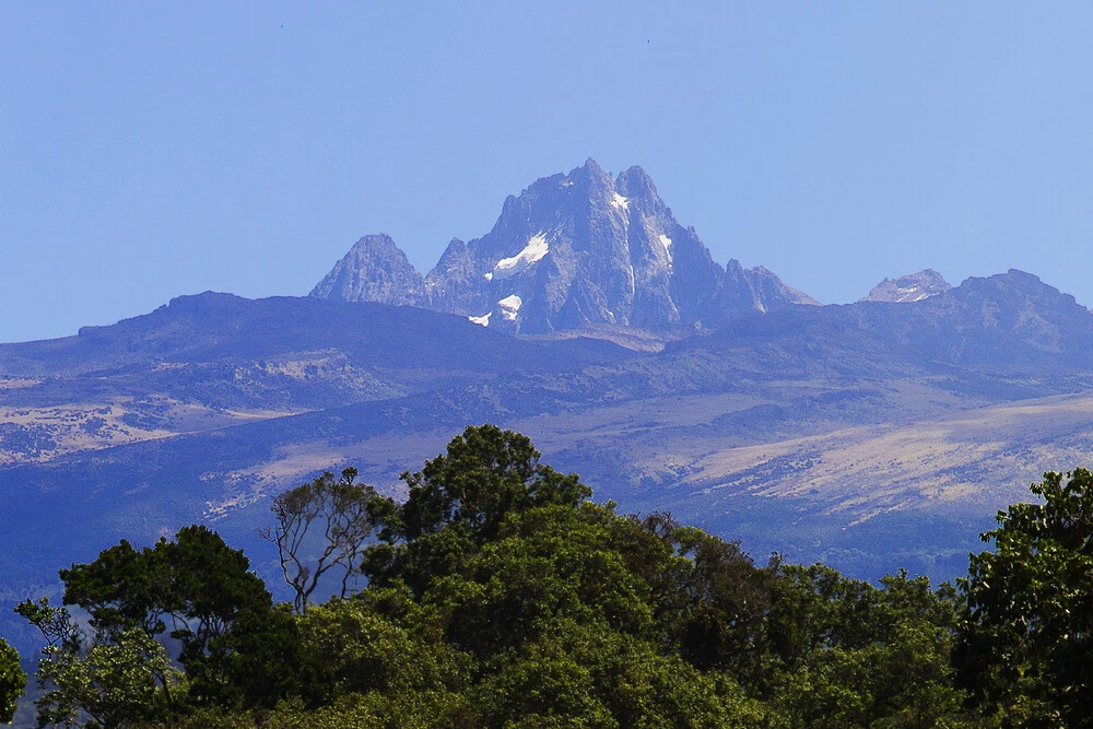 Mount Kenya, Africa’s second-highest peak, offers breathtaking landscapes, unique flora and fauna, and unforgettable hiking adventures. Mount Kenya, standing proudly as Africa’s second-highest mountain, is a UNESCO World Heritage site and one of Kenya’s most iconic landmarks. Rising to 5,199 meters (17,057 feet), this majestic peak offers a truly diverse ecosystem that ranges from dense forests and bamboo thickets to alpine meadows and glacial summits. Its rugged terrain and spectacular landscapes make it a paradise for hikers and nature enthusiasts, with routes that cater to varying levels of expertise—from challenging climbs to leisurely forest walks. The mountain is home to unique flora and fauna, including the remarkable giant lobelias and groundsels found only in these high-altitude regions. Wildlife such as elephants, buffalo, and Colobus monkeys inhabit the lower forests, while elusive species like the Mount Kenya hyrax and alpine birds make the higher slopes their home. Mount Kenya is also a site of cultural significance, holding a revered place in local Kikuyu and Meru communities who view it as a sacred dwelling of the gods. For climbers and adventurers, the ascent to peaks like Lenana, Batian, and Nelion is a test of endurance and awe-inspiring natural beauty, with panoramic views of the plains below. Beyond its natural beauty and adventure appeal, Mount Kenya offers a profound sense of connection to Kenya's heritage and ecological richness. Whether trekking through lush forests, crossing high-altitude moorlands, or reaching snowy summits, every step is a journey through one of Kenya’s most spectacular wonders.